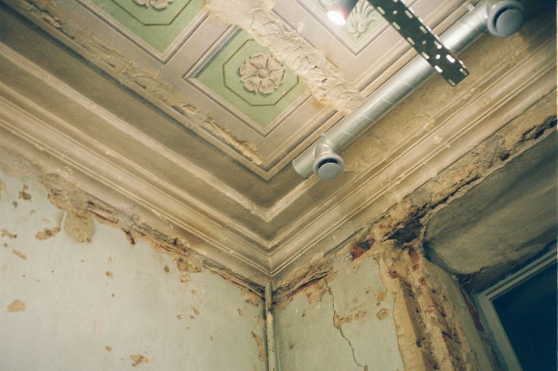 Peeling paint on a water-damaged ceiling